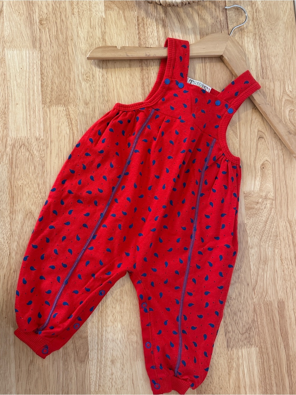 Red toddler romper with blue paisley shape print